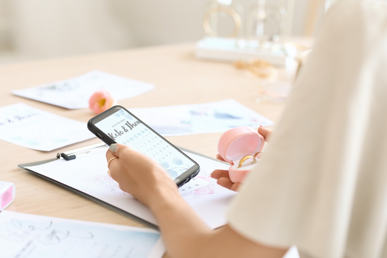 Female Wedding Planner with Phone Working in Office, Closeup